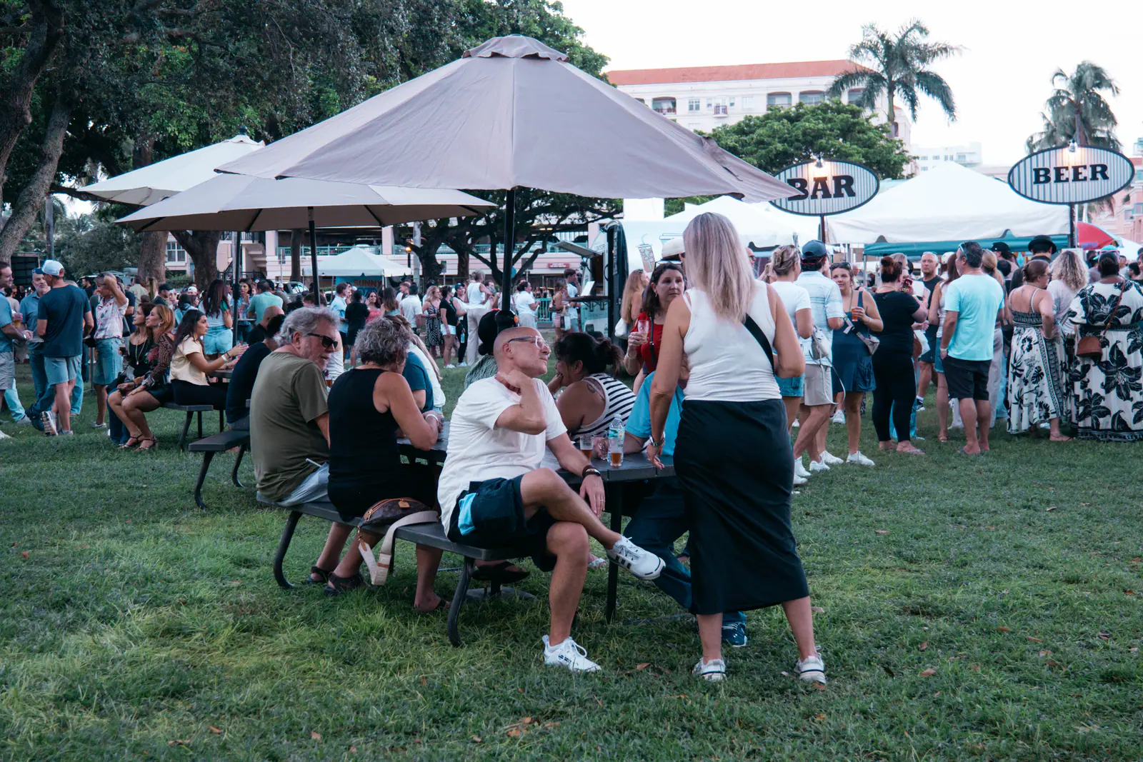 Festival-goers gathered on the lawn near the bar and beer tents