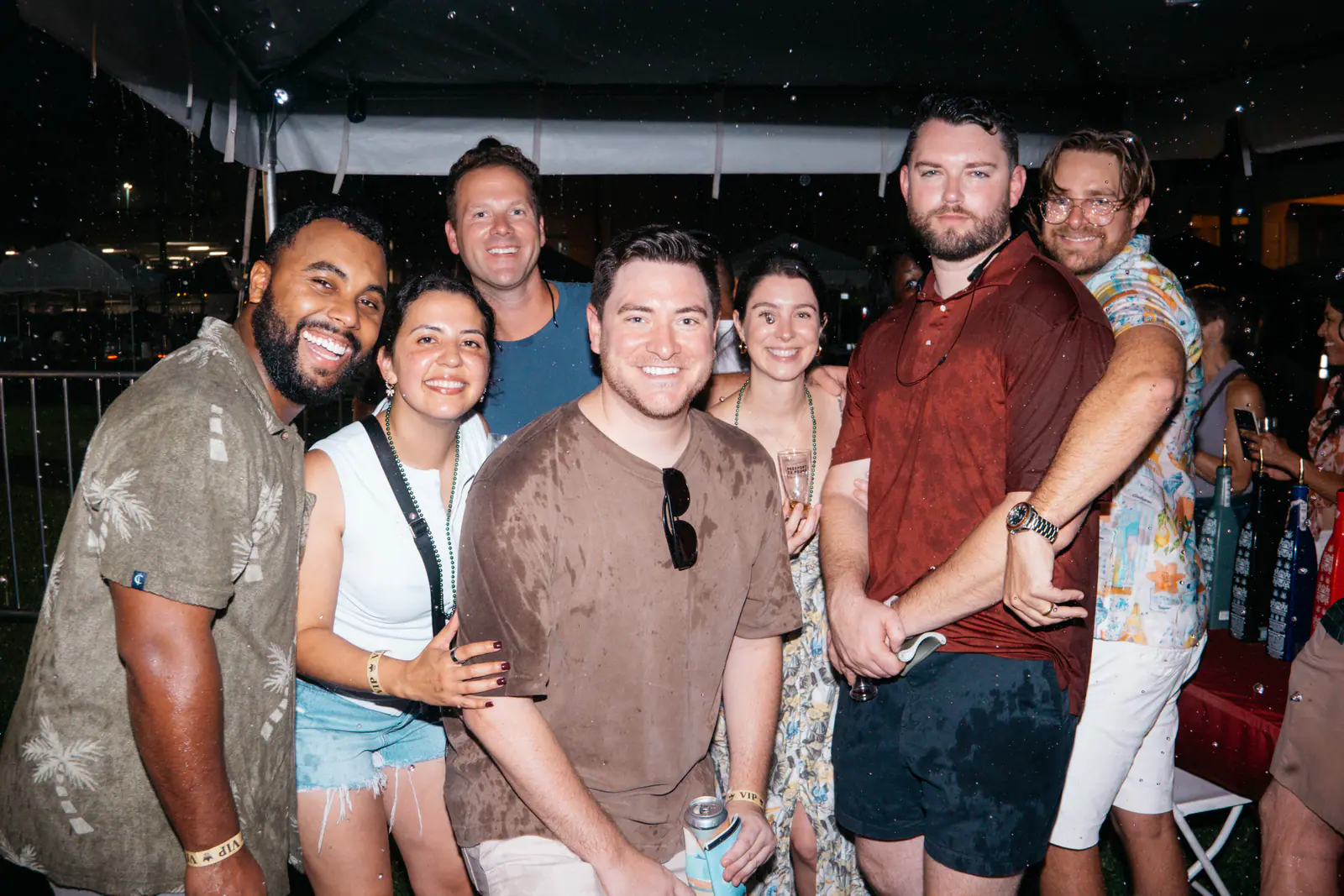 A group of friends posing together at night