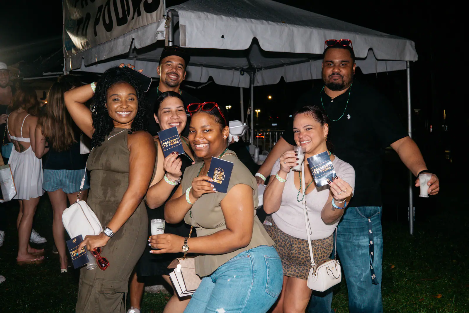 Friends showing off their Passport Books at night
