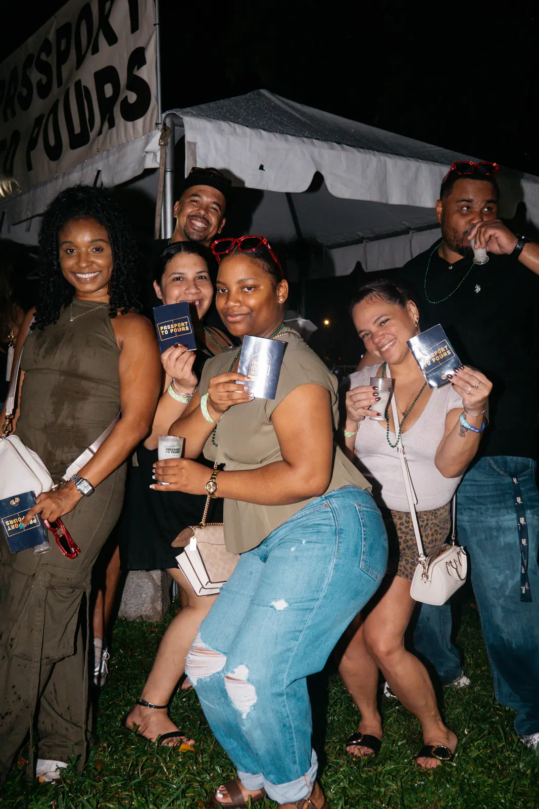 Friends posing with their Passport Books and sample cups