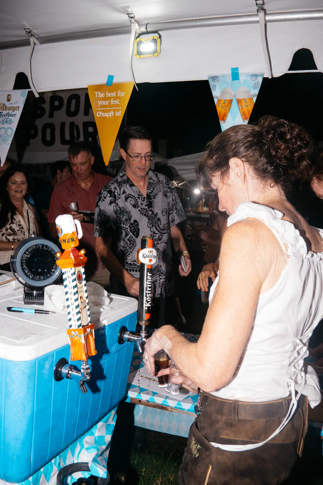 A server pouring a sample from a tap