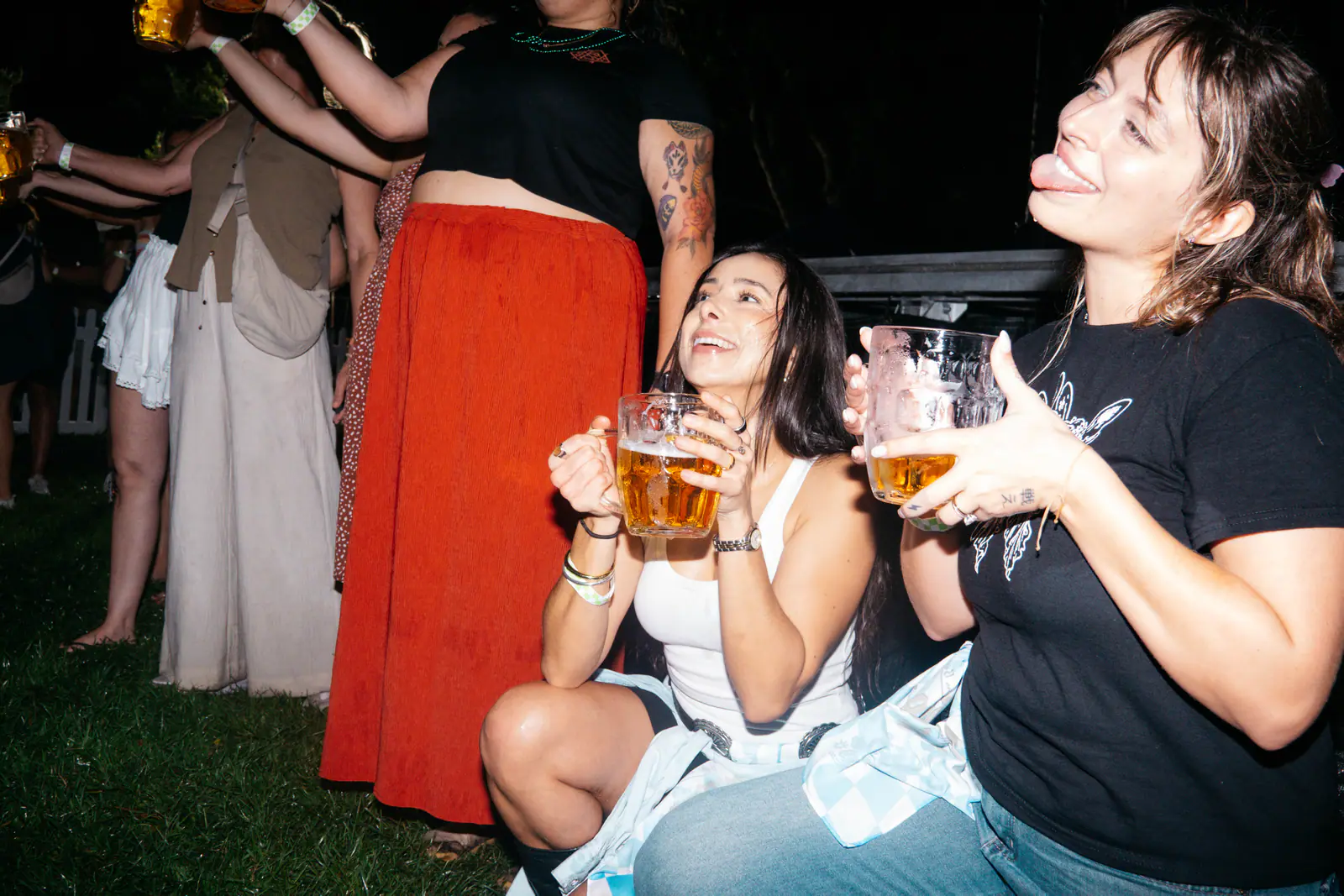 Guests cheering with beer steins on the lawn
