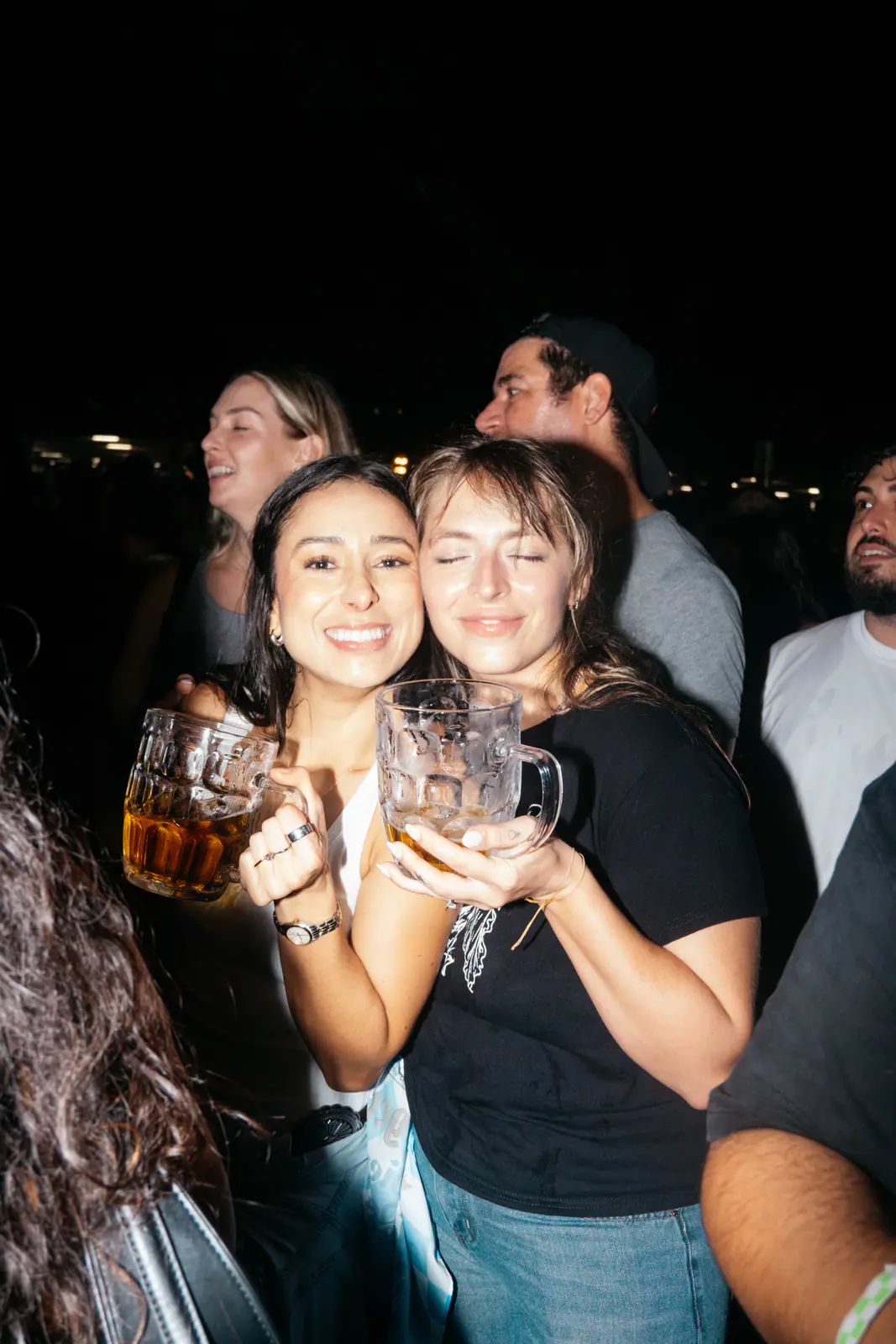 Two friends smiling with their beer steins
