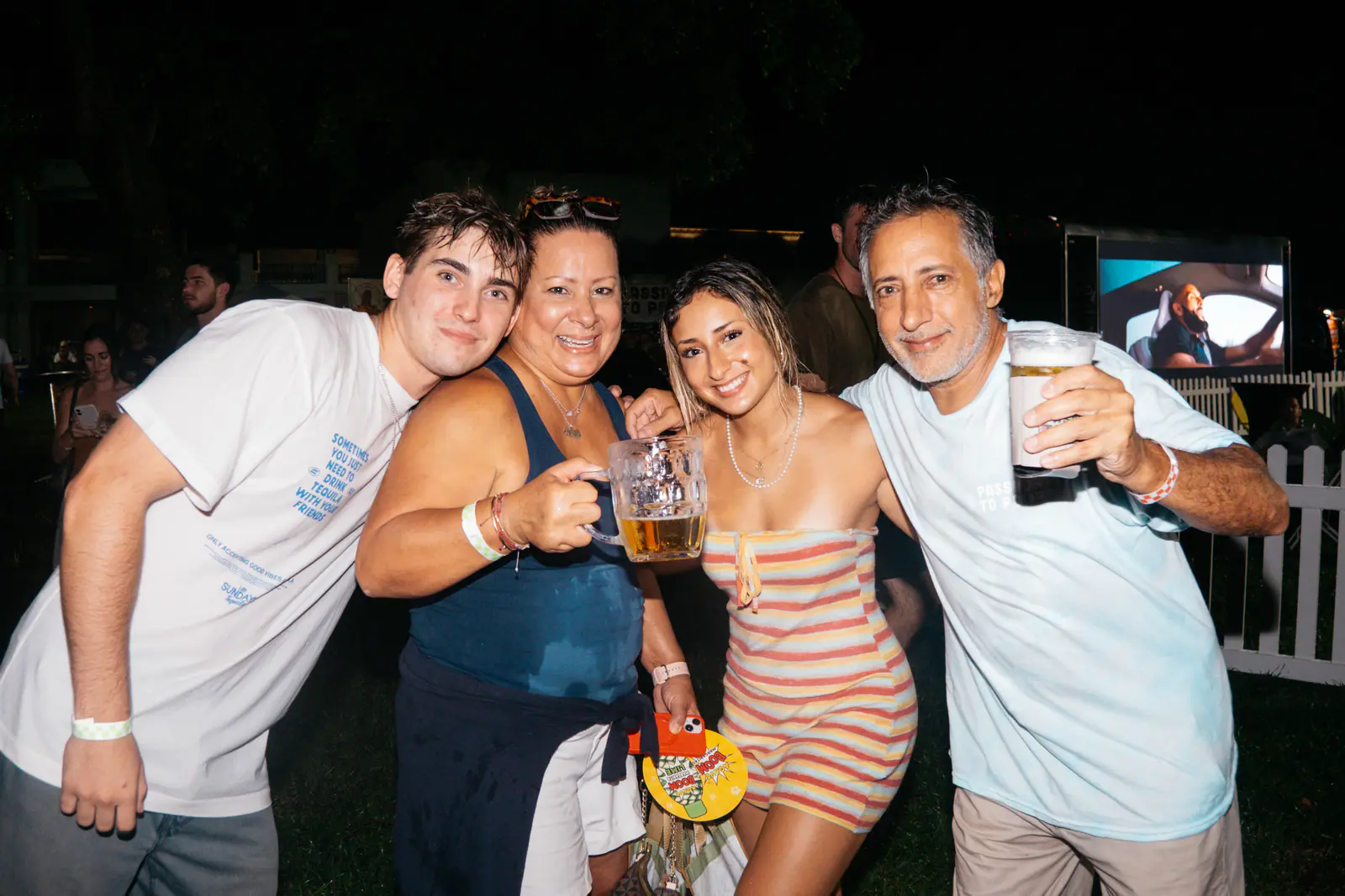 Four guests posing with a beer stein
