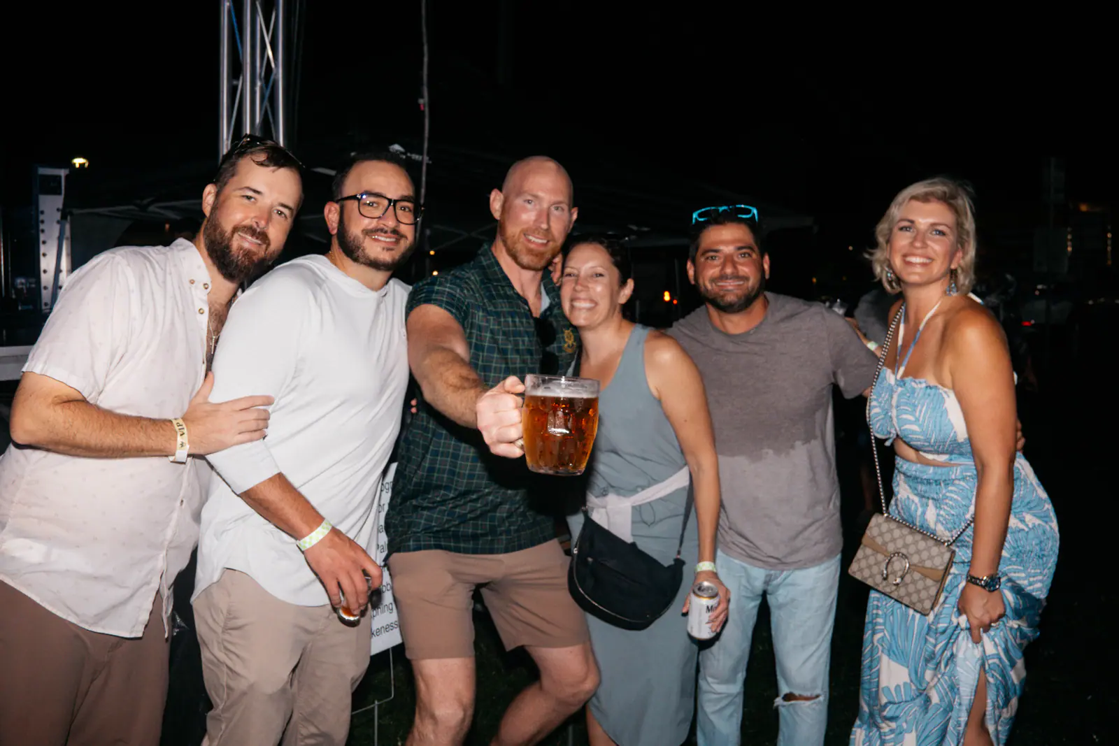 A group of friends posing with a beer stein